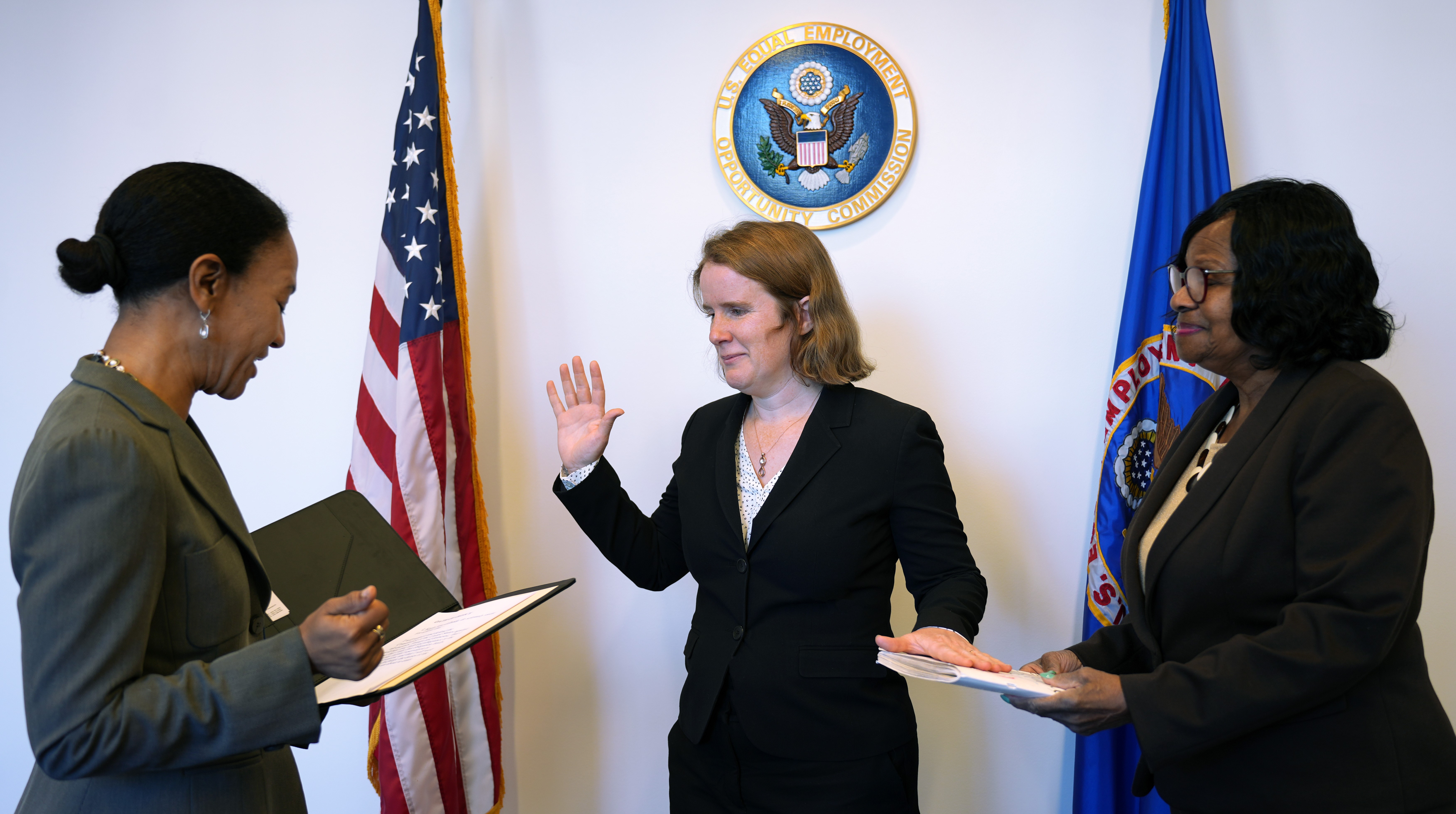 EEOC Chair Charlotte A. Burrows administers the oath of office to the agency’s new General Counsel Karla Gilbride Oct. 23, with Gwendolyn Young Reams attending